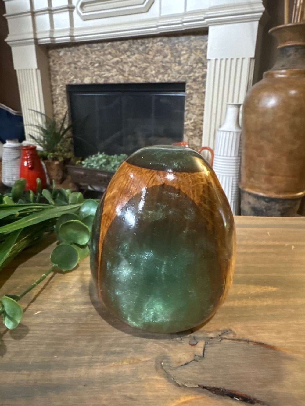 This item is a handcrafted egg made from a combination of wood and resin.